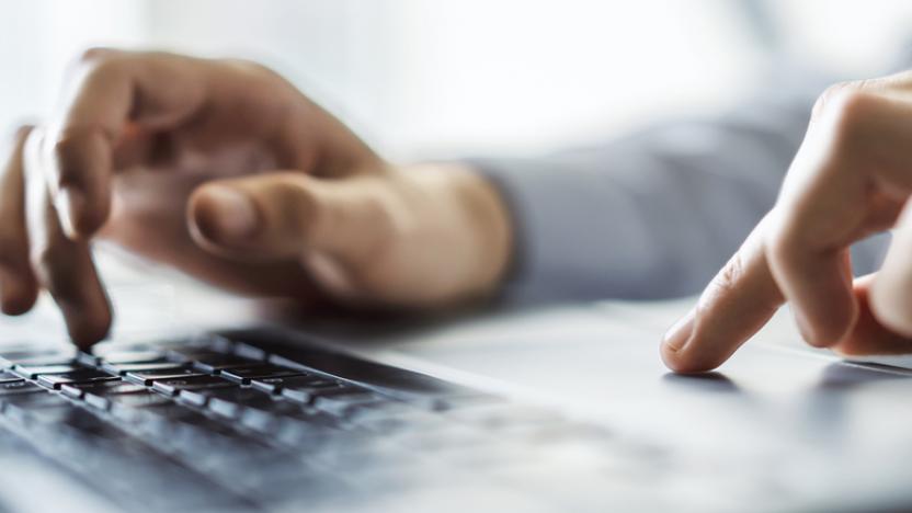 person typing on laptop keyboard