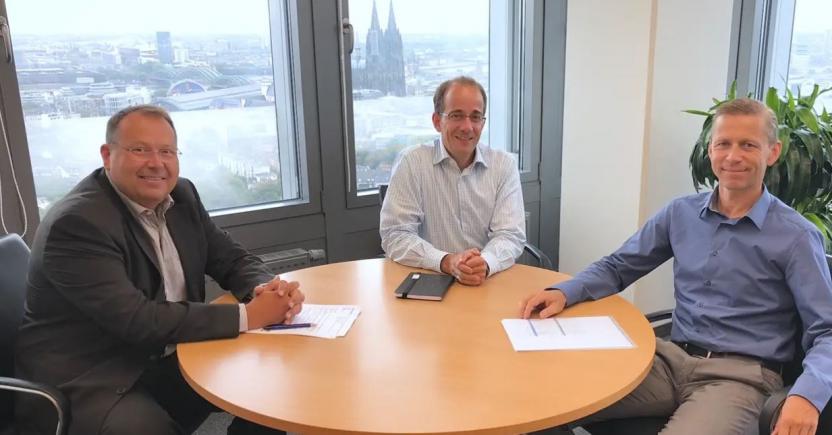 Three colleagues sat at a table